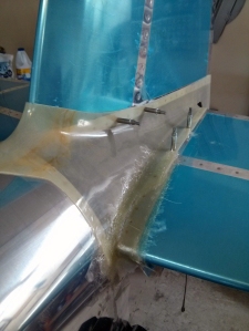 After cutting away the bad area of the empennage fairing, I put down six layers of glass.  Wrapping it around the leading edge of the horizontal stabilizer was easier than I thought it would be.